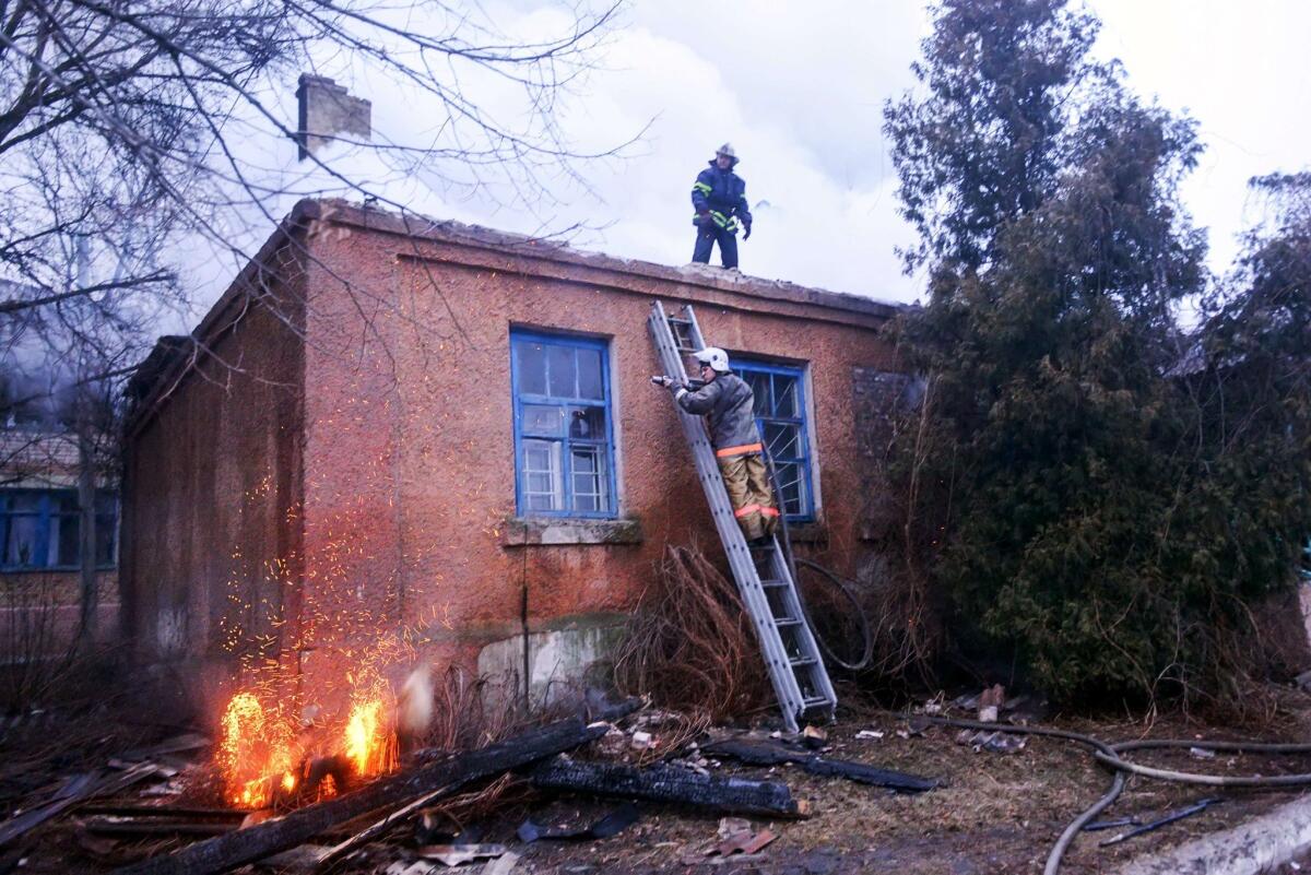 Firefighters try to save a clinic after shelling in the eastern Ukrainian city of Artemivsk on Saturday.