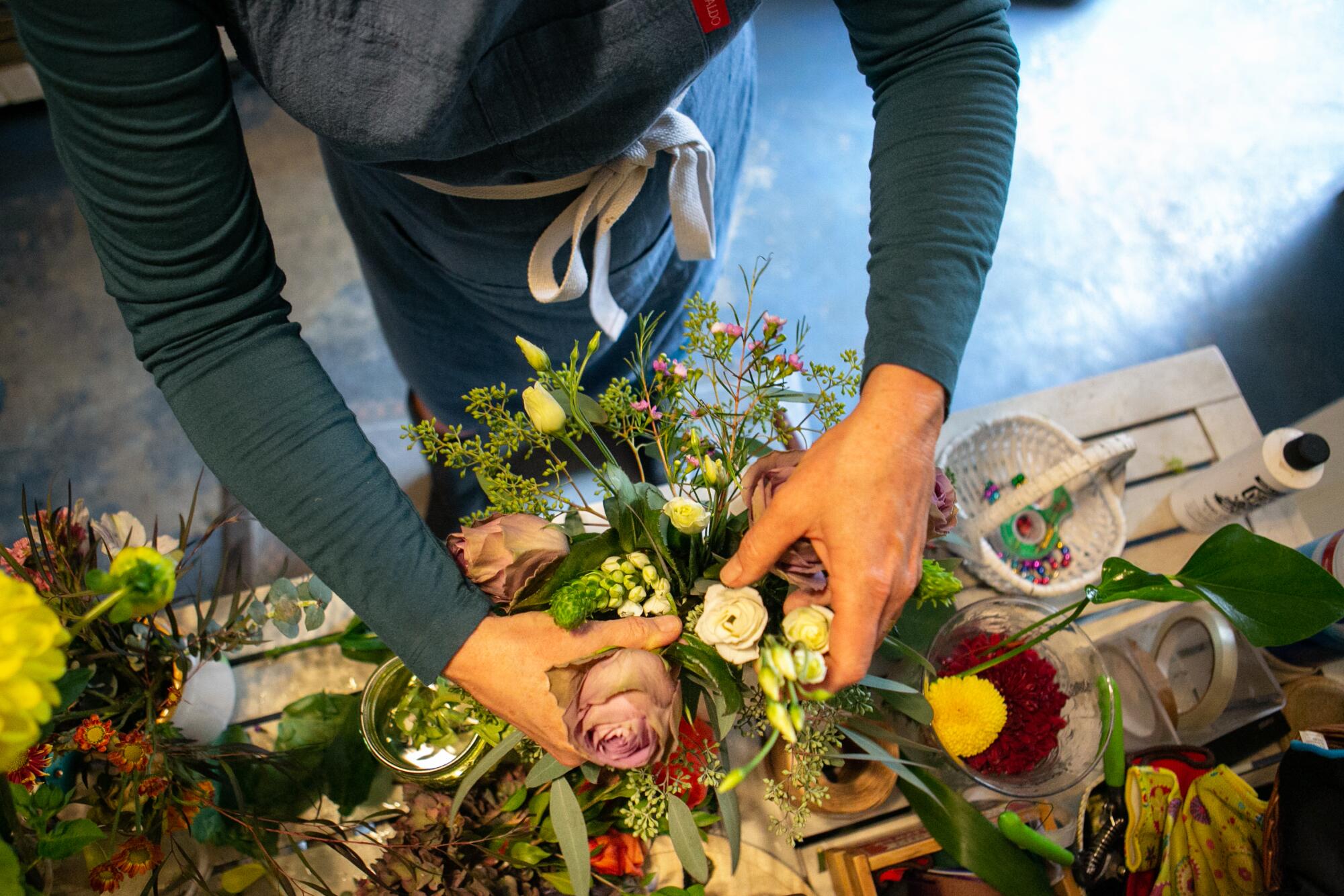 Susan Sanchez arranges flowers at Fridas Pickles in San Gabriel.