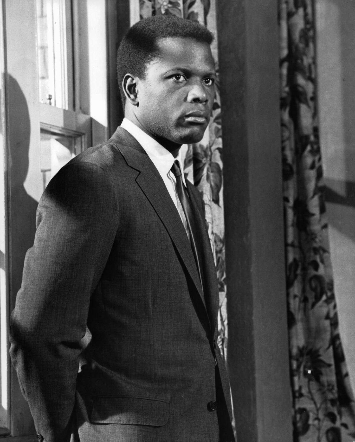 Sidney Poitier stands in an open doorway in a scene from the film 'To Sir, With Love” (1967)