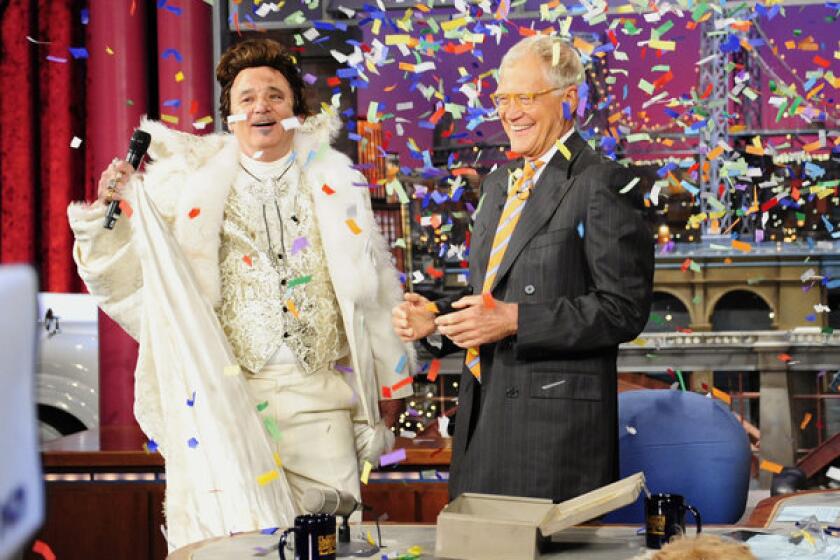 Actor Bill Murray, left, dressed as Liberace, joins host David Letterman on the set of "The Late Show" with David Letterman" as the show celebrates its 20th anniversary.