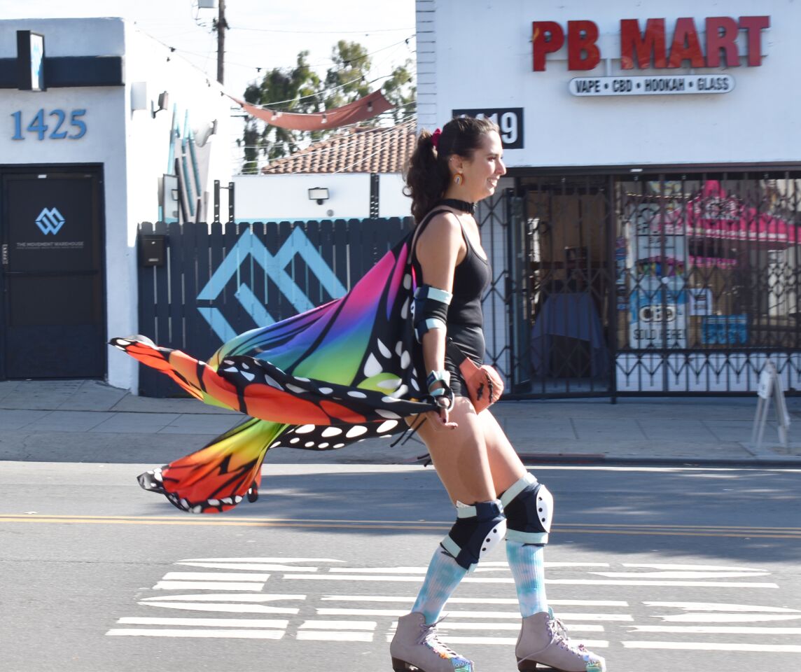 A roller skater wore butterfly “wings” that fluttered behind her while cruising down Garnet Avenue.