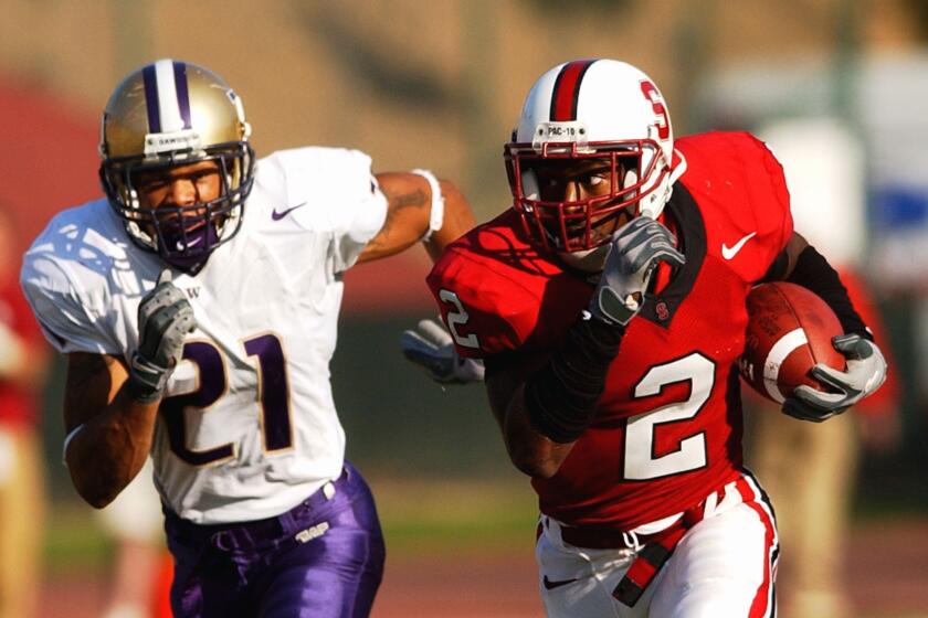 Stanford cornerback Stanley Wilson (2) is chased by receiver Sonny Shackelford (21) after intercepting the ball during the second half Saturday, Oct. 2, 2004, in Stanford, Calif. Stanford won 27–13. (AP Photo/Marcio Jose Sanchez)