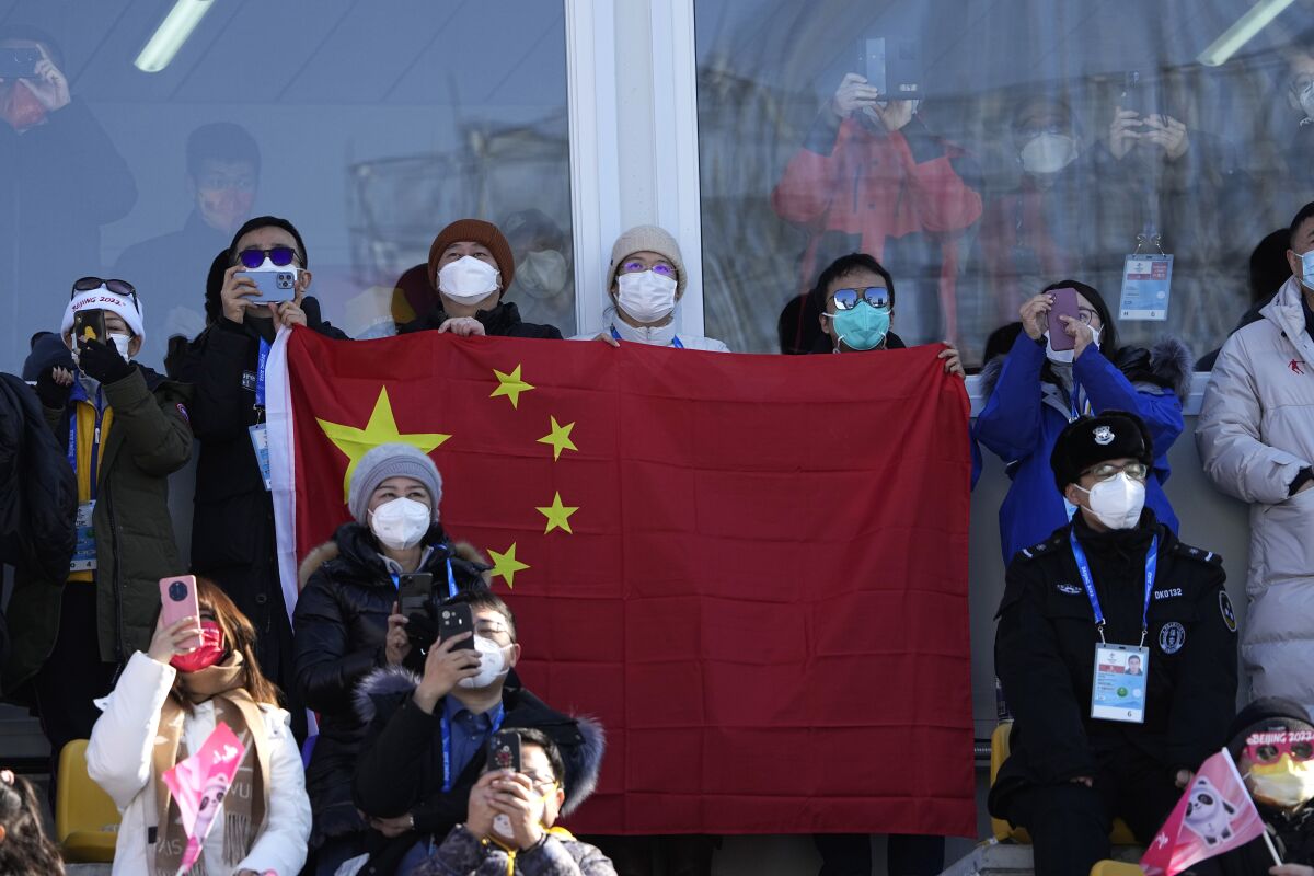 Spectators wait for China's Eileen Gu to compete during the women's freestyle skiing big air finals 