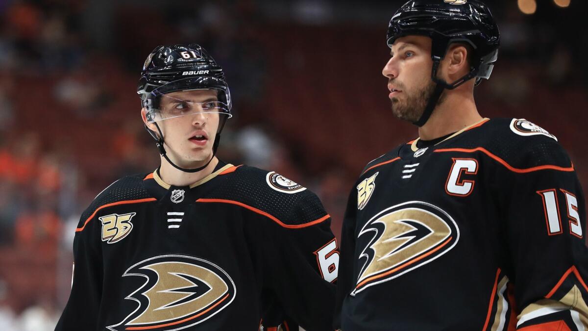 Ducks' Troy Terry, left, talks with Ryan Getzlaf during the first period of a preseason game against the Arizona Coyotes at Honda Center on Sept. 24.