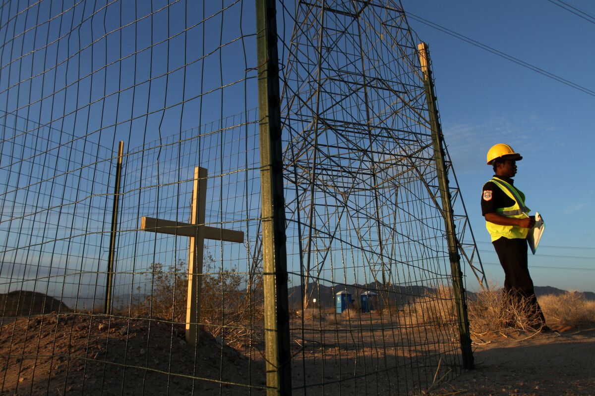 A cross marks the site where ancient humans remains were found in the vicinity of NextEra's $1-billion Genesis solar project near Blythe. The Colorado River Indian Tribes have now sued to block construction of a second project that would replace 4,000 acres of ancestral homelands in the Mojave Desert with reflective photovoltaic panels.