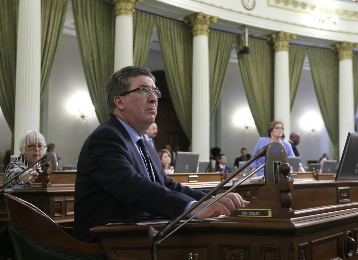 Assemblyman Ken Cooley (D-Rancho Cordova) watches June 15 as the votes are posted for his measure that limits the time high school and middle school football players can be engaged in full-contact drills. The Senate has now approved the bill as well and sent to the governor.