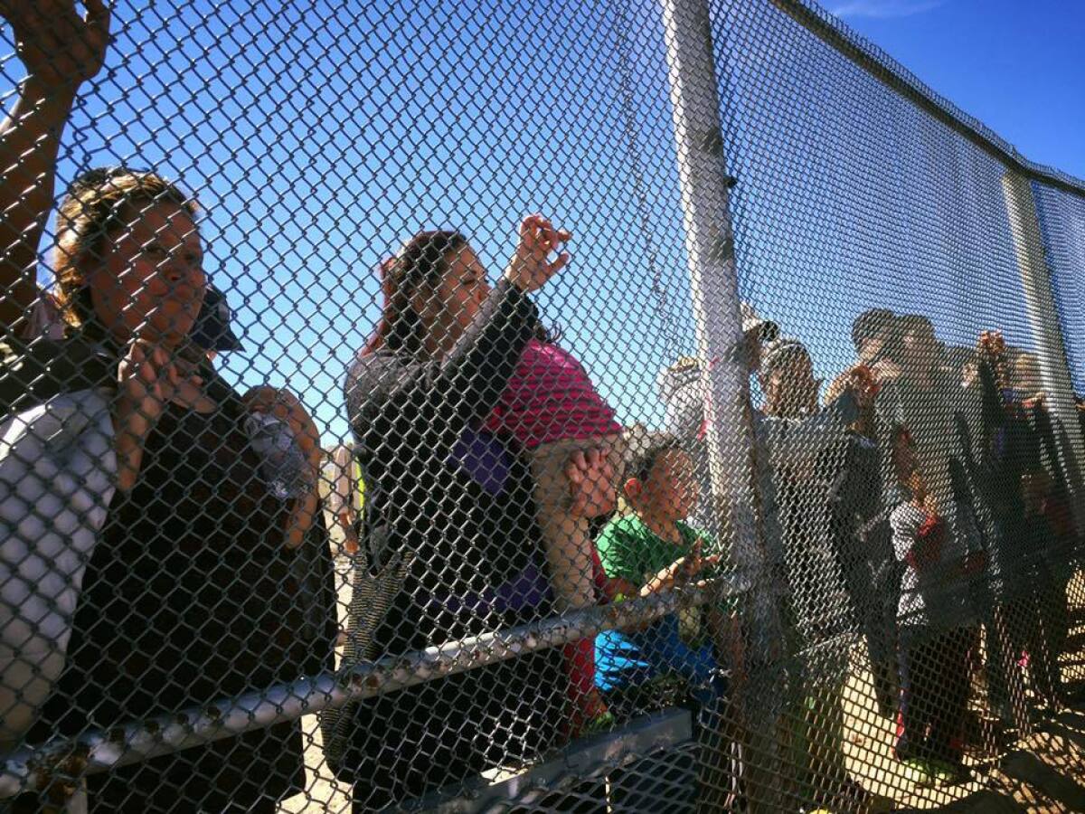 As time comes for goodbyes, the family on the Mexican side clutches the border fence.