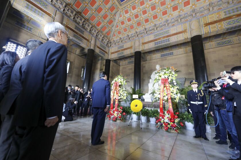 In this photo released by the Ma Ying-jeou Office, former Taiwan President Ma Ying-jeou, center, stands at the Mausoleum of Sun Yat-sen in Nanjing in eastern China's Jiangsu Province, Tuesday, March 28, 2023. Ma departed for a tour of China on Monday, in what he called an attempt to reduce tensions a day after Taiwan lost one of its few remaining diplomatic partners to China. (Ma Ying-jeou Office via AP)