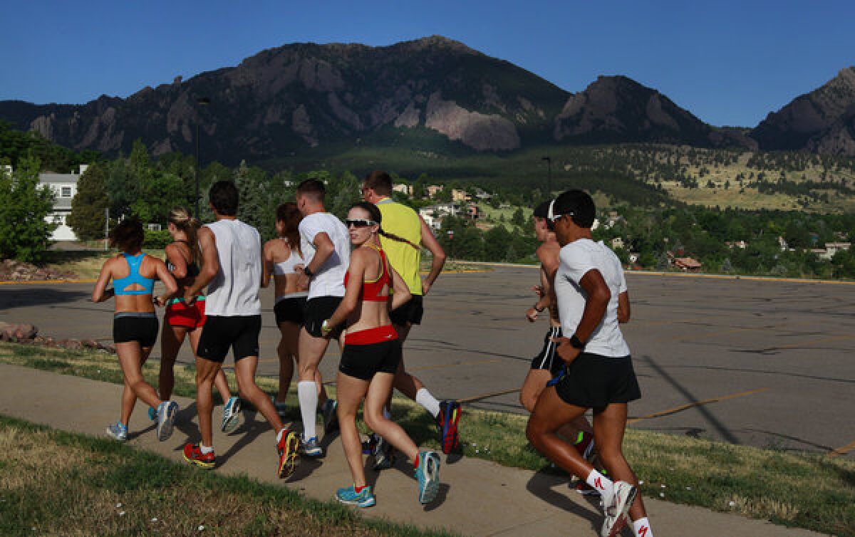 A group a runners work out together in Boulder, Colo.