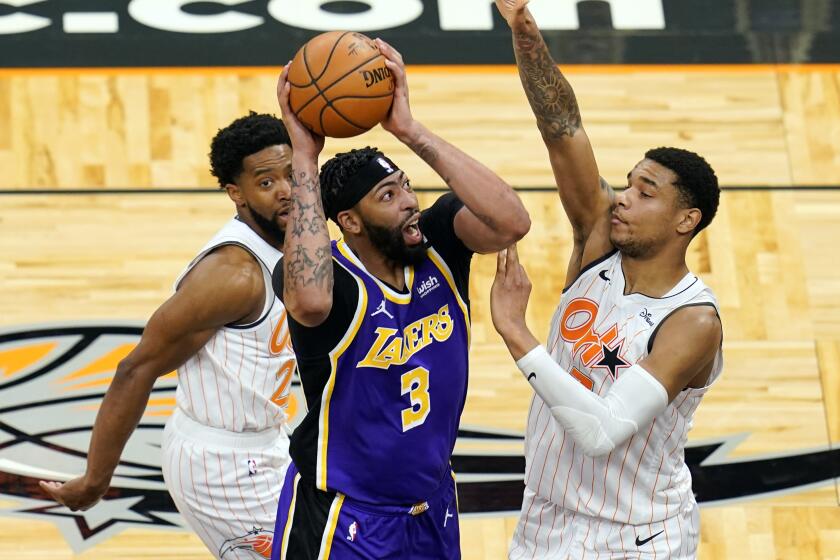 Los Angeles Lakers forward Anthony Davis (3) takes shot as he gets between Orlando Magic guard Chasson Randle.