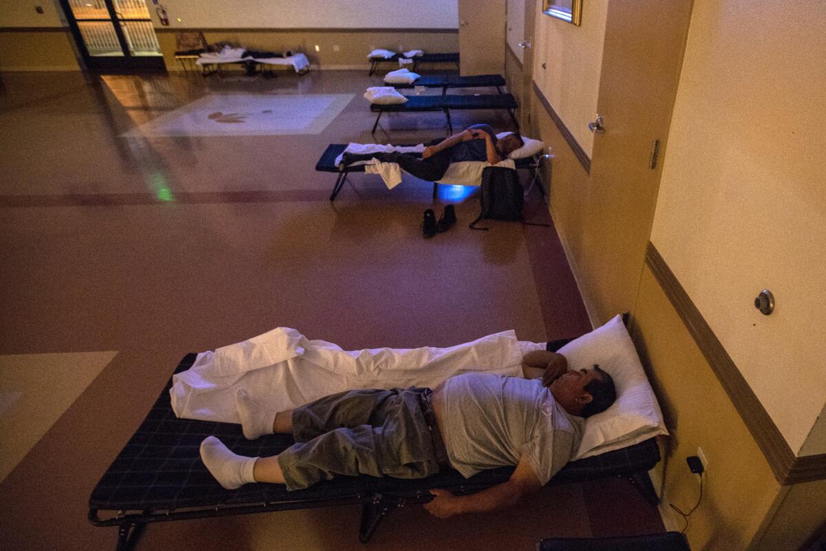 Jose Luis, 66, in foreground, and other migrant workers sleep at Our Lady of Guadalupe shelter in Mecca. (Irfan Khan / Los Angeles Times)