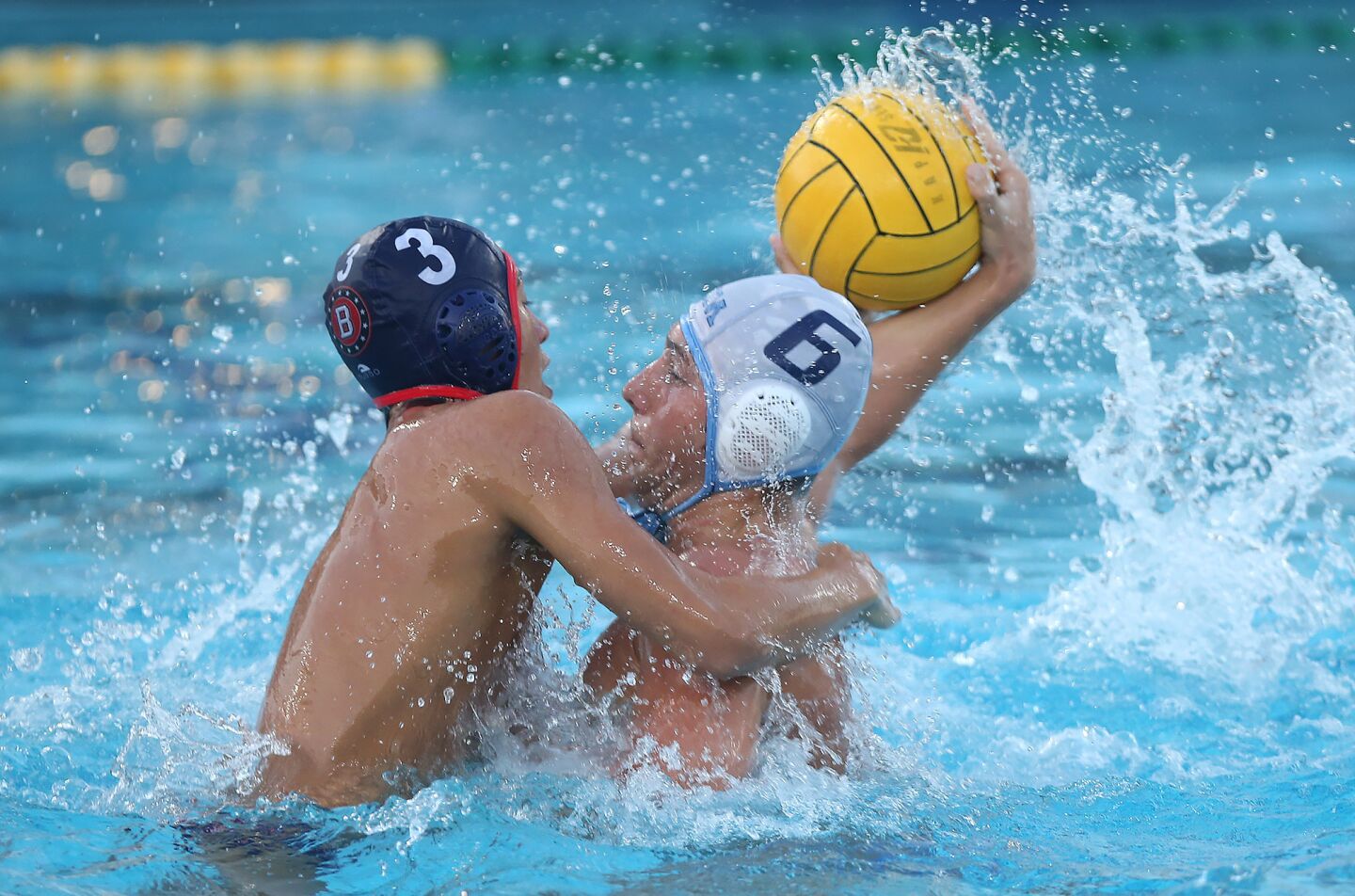Beckman High's Keanu Pascual (3) disrupts a shot by Corona Del Mar High's Matt Ueberroth in front of the net during wild-card round of the CIF Southern Section Division 2 playoffs at Beckman on Tuesday.