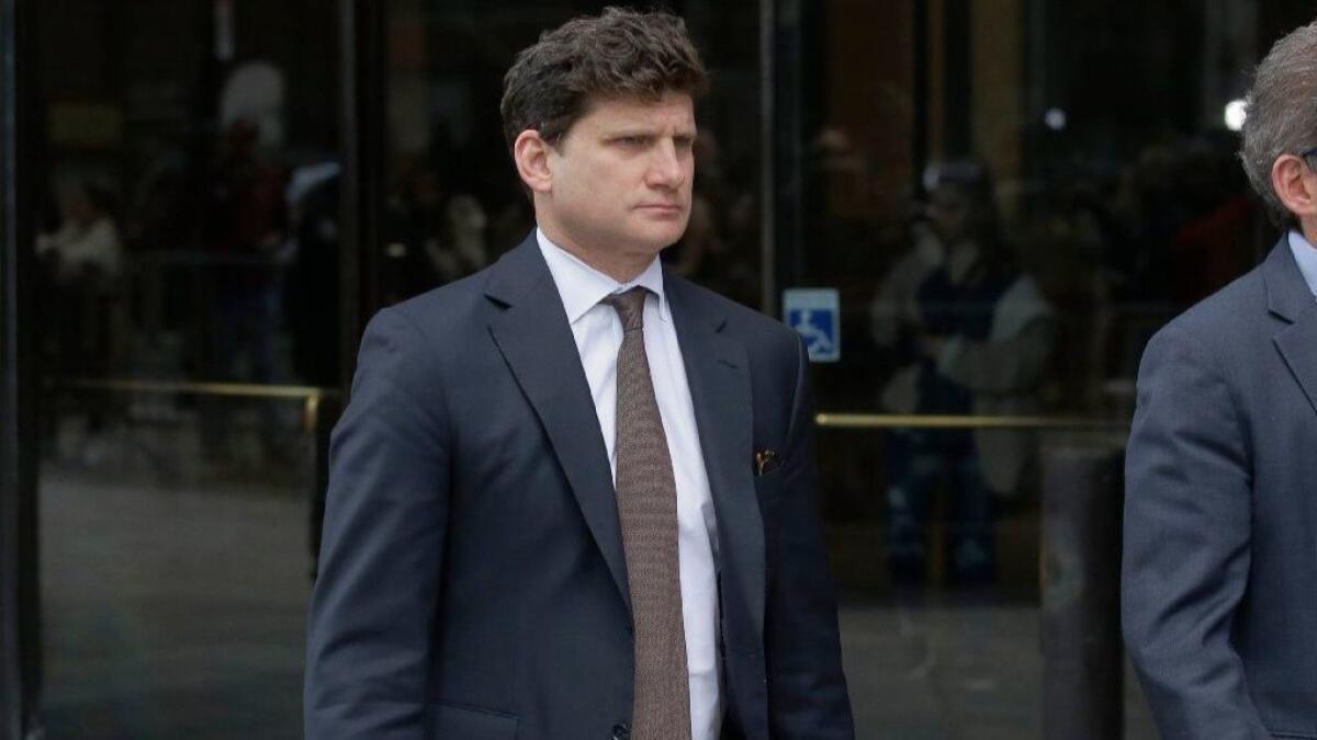 Gordon Caplan arrives at federal court in Boston on Wednesday to face charges in a nationwide college admissions bribery scandal.