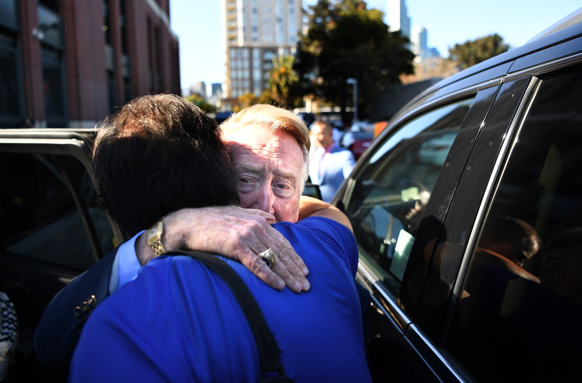 Dodgers broadcast announcer Vin Scully says goodbye to Dodgers team photographer Jon SooHoo