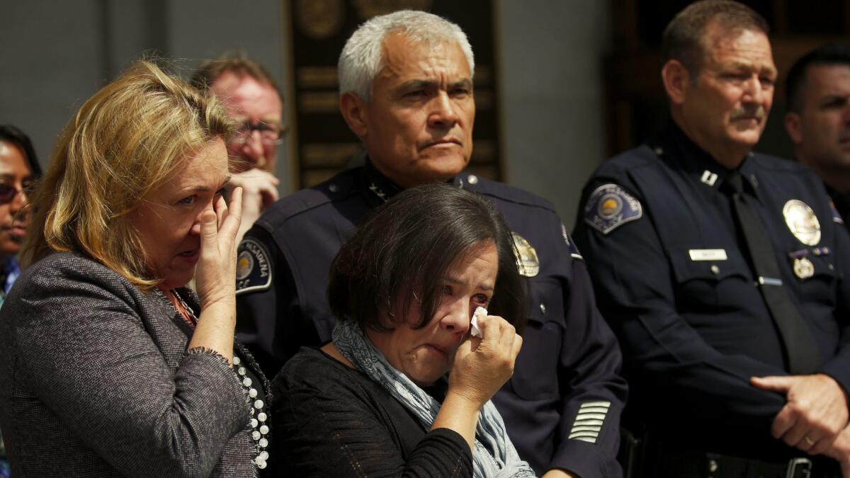Ana Estevez, center, the mother of Aramazd Andressian Jr., cries during a news conference Wednesday at the Hall of Justice in L.A. There is a $20,000 reward for information in her son's April disappearance.