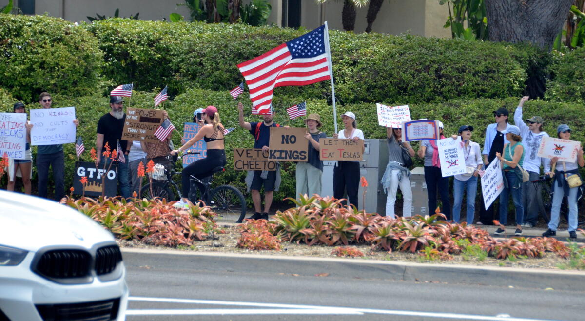 Hundreds statement Coast Highway astatine Jamboree Road to return portion successful the June 14, 2025, "No Kings" protest.