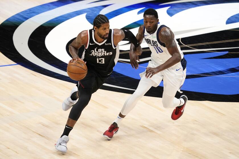 The Clippers' Paul George works against the Dallas Mavericks' Dorian Finney-Smith on May 30, 2021.