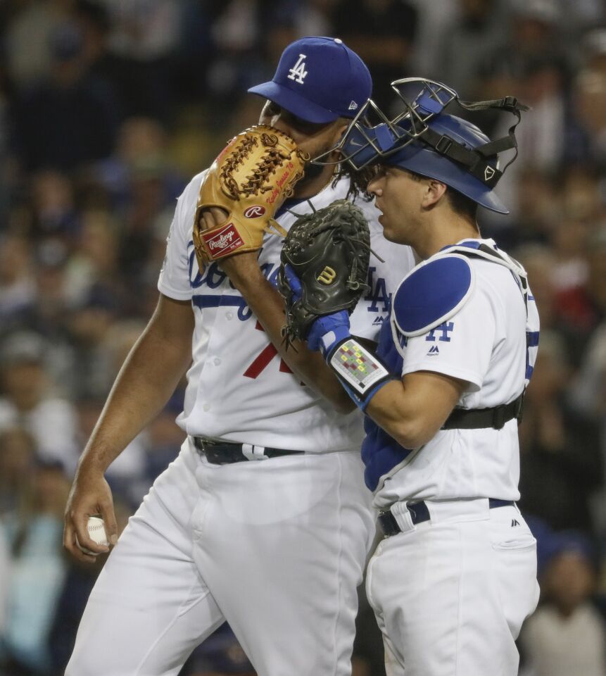 Kenley Jansen and Austin Barnes consult each other during ninth inning action.