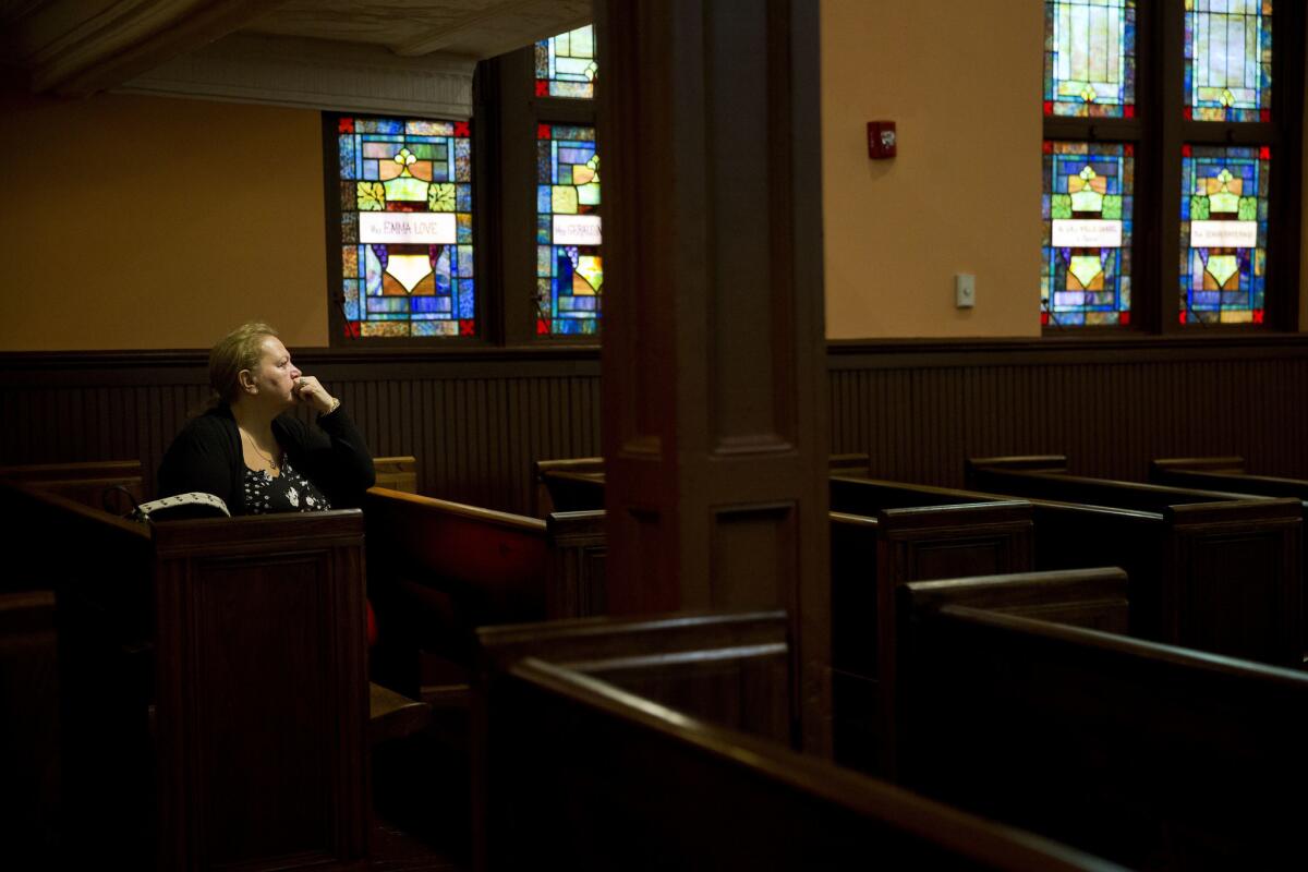 Julie Kenny, of Sheffield, England, listens to a recorded speech of the Rev. Martin Luther King Jr. play in the sanctuary of Ebenezer Baptist Church in Atlanta, where King preached, on the 50th anniversary of his assassination.