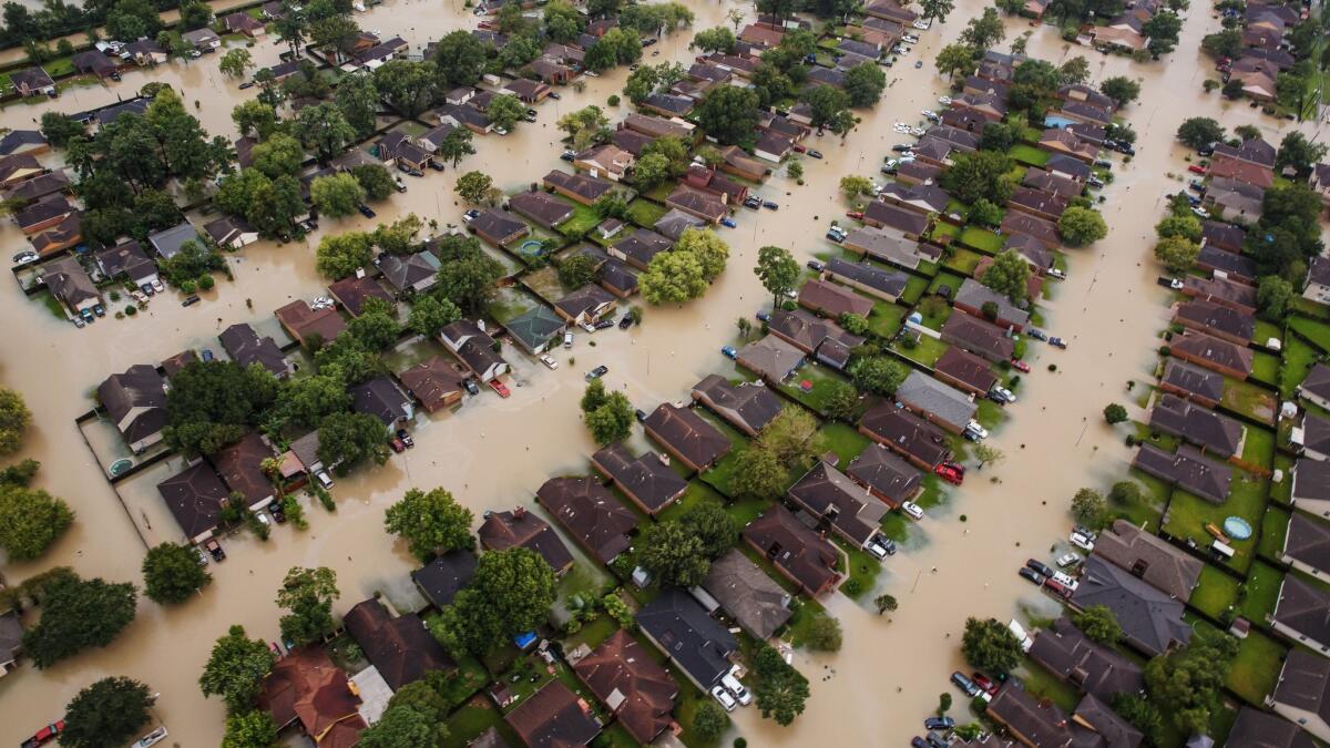 Residential streets east of downtown Houston are filled with muddy water following Tropical Storm Harvey in August.