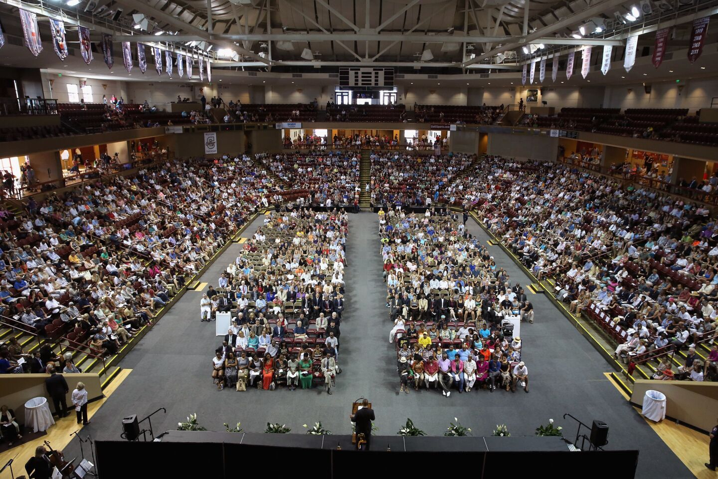 Thousands of people gather for a city-sponsored prayer vigil for the nine victims of the Emanuel AME Church shooting at the College of Charleston TD Arena.