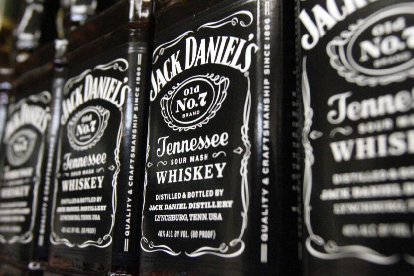 FILE - In this Dec. 5, 2011, file photo, bottles of Jack Daniel's Tennessee Whiskey line the shelves of a liquor outlet in Montpelier, Vt. Brown-Forman Corp. (BF.A) on Wednesday, June 6, 2018, reported fiscal fourth-quarter earnings of $110 million. (AP Photo/Toby Talbot, File)