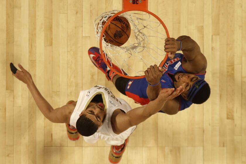 Piston center Andre Drummond of Team Hill throws down a dunk over Pelicans power forward Anthony Davis of Team Webber in the Rising Stars Challenge game.