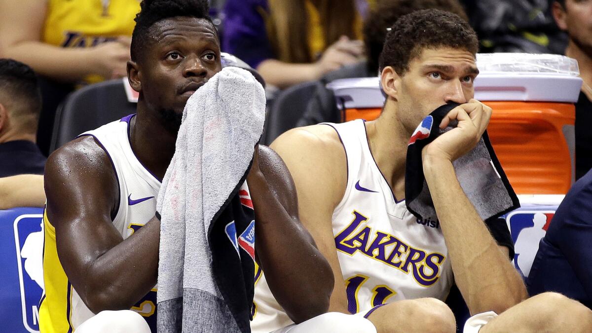 Lakers forward Julius Randle, left, and center Brook Lopez watch the closing moments of the Lakers 113-102 loss to the Kings on Wednesday night in Sacramento