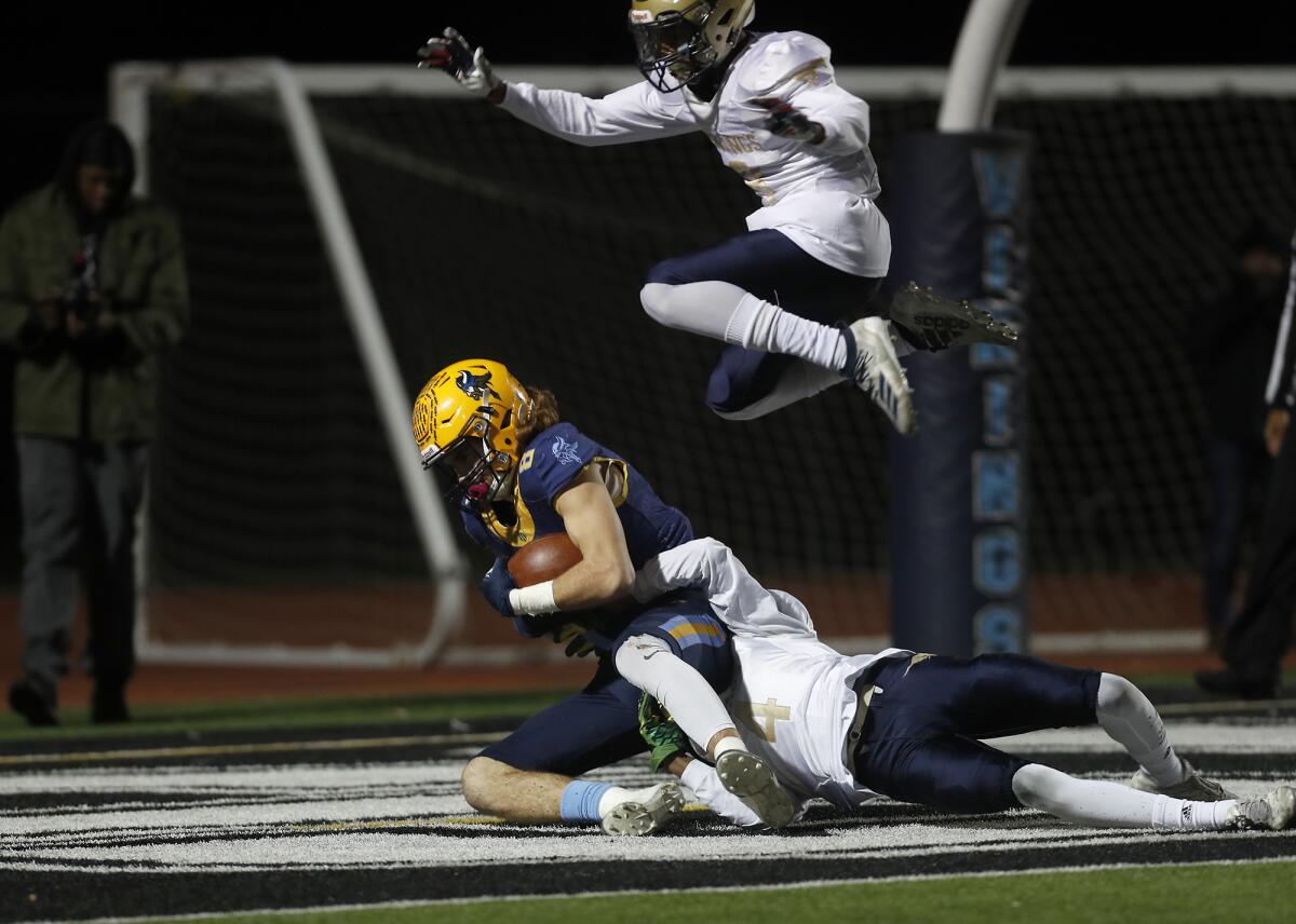 Marina's Dane Brenton (8) catches a two-point conversion pass against Muir's Jamier Johnson (4) in the CIF Southern Section Division 11 title game on Nov. 29 at Westminster High.