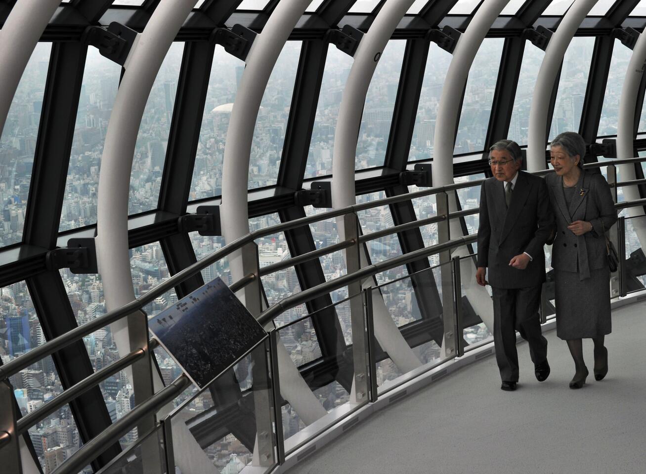 Japanese Emperor Akihito, left, and Empress Michiko enjoy the view from an observation area in Tokyo Skytree.