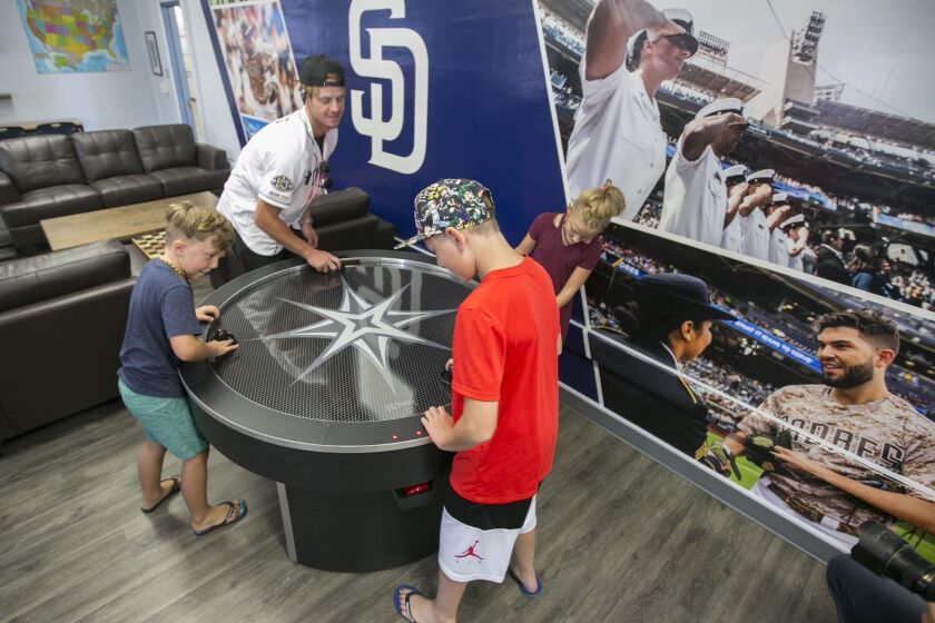 John Gibbins  U-T Padres outfielder Wil Myers was on hand Monday for the dedication of the USO Military Kids Club at Dewey Elementary School in Point Loma. Here he played air hockey with 8-year-old twins Traeh (right) and Trenton Peek. With hat and red shirt in foreground is Reece Olinger, 12. The Padres donated $50,000 to build the club at the school, where 98 percent of the students are from military families. Jerome’s donated the furniture, and Navy personnel helped with the physical demolition and construction of the new space.