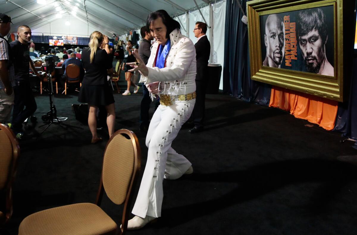 An Elvis impersonator gets in on the act to promote the Mayweather-Pacquiao fight at the MGM Grand media tent for a promotion video on ESPN.