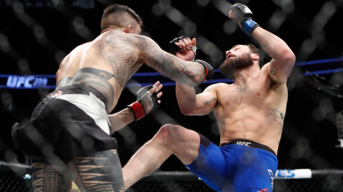 Tyson Pedro knocks down Paul Craig during their UFC 209 bout.