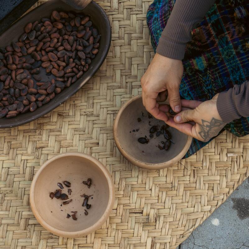 With patience and an almost meditative process, Villegas sits down to peel each roasted cacao seed.
