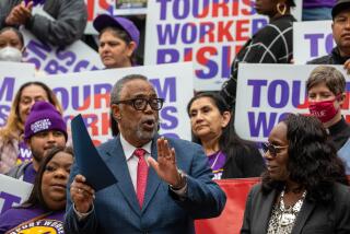 LOS ANGELES, CA - APRIL 12: Los Angeles City Councilmember Curren Price, center, applauds Yvonne Wheeler, President, LA County Federation of Labor after she spoke on support of a motion introduced by Price to raise the wages for tourism workers to $25 an hour and fix loopholes in current policies to keep workers healthy and housed. Councilman Price and unions SEIU United Service Workers West and UNITE HERE Local 11at press conference held on the steps of City Hall on Wednesday, April 12, 2023 in Los Angeles, CA. (Irfan Khan / Los Angeles Times)