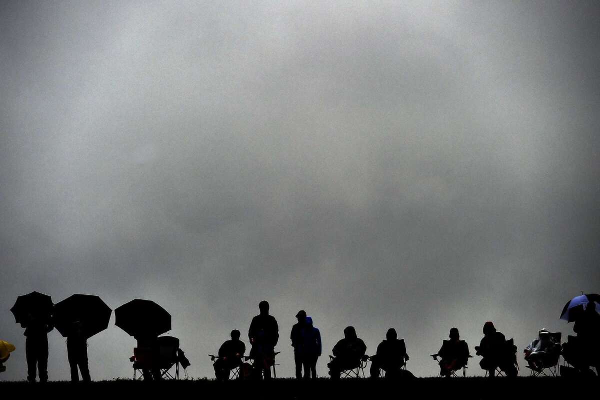 Spectators brave the rain to watch the qualifying session for the U.S. Formula One Grand Prix at the Circuit of the Americas in Austin, Texas, on Sunday.