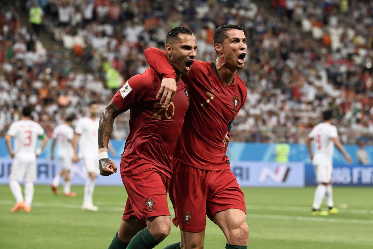 Portugal's Ricardo Quaresma, left, celebrates with teammate Cristiano Ronaldo after scoring against Iran on Monday.