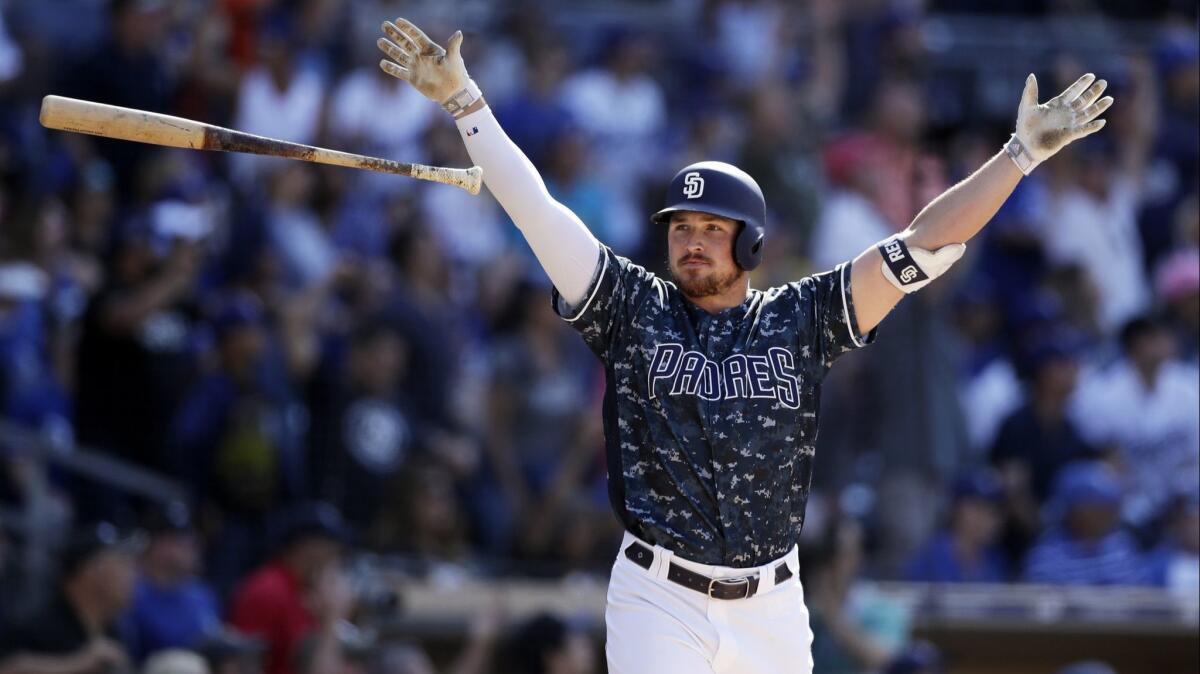 San Diego’s Hunter Renfroe glances toward the Padres dugout after hitting a walkoff grand slam to cap off an 8-5 victory over the Dodgers on Sunday.