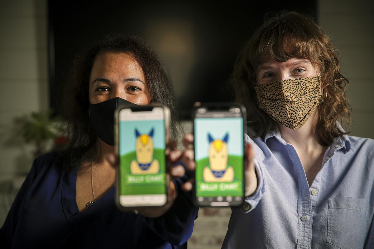 Cecilia Santiago-Gonzalez and Zoe Lance manage Billy Chat, an AI robot for student communication at Cal Poly Pomona.