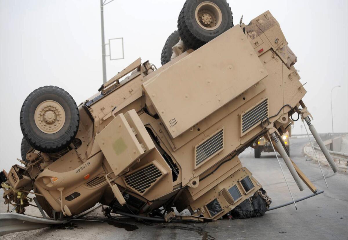 A Mine-Resistant Ambush-Protected vehicle rests on its turret and hood after a 2009 rollover in Iraq.