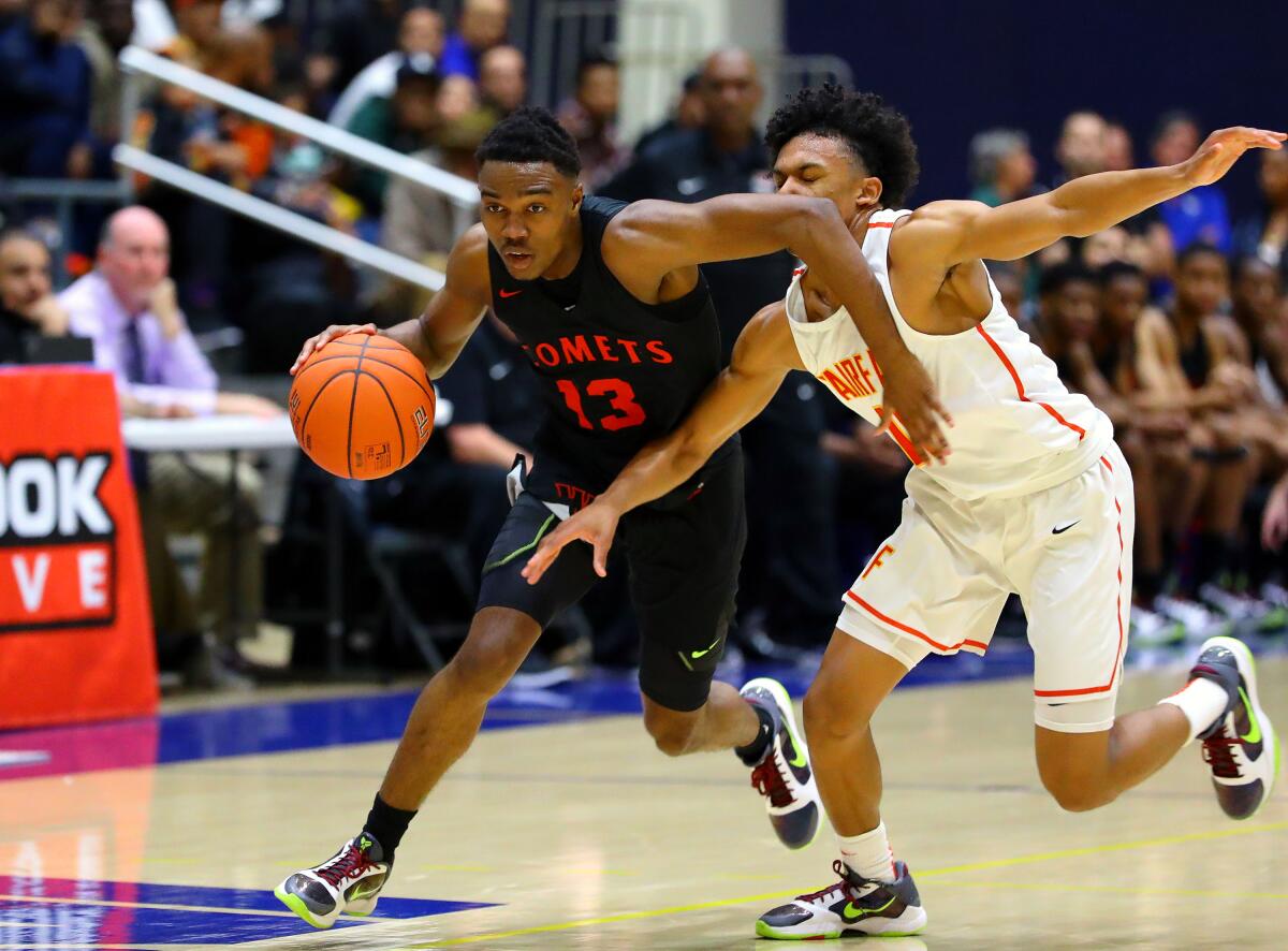 Ky-mani Pollard of Westchester goes by Barry Wilds of Fairfax in the 2020 City Section Open Division final. 