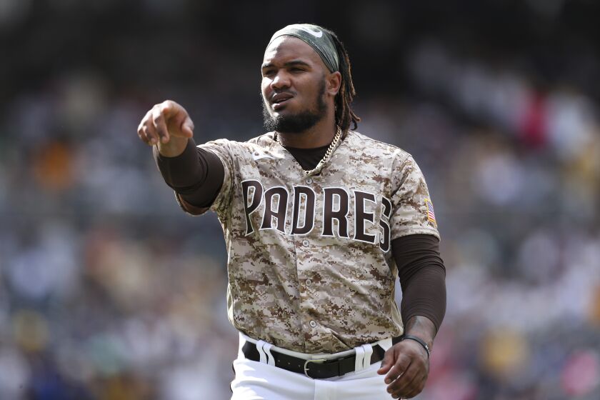 San Diego Padres' Eguy Rosario points towards the dugout in a baseball game against the Los Angeles Dodgers Sunday, Sept. 11, 2022, in San Diego. (AP Photo/Derrick Tuskan)