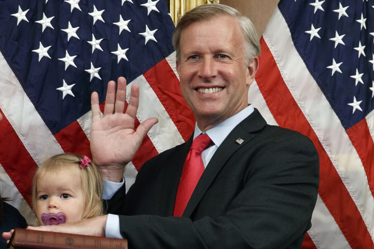 FILE - Congressman Chris Jacobs, R-N.Y., center, poses for a photo with his daughter Anna, 1, during a ceremonial swearing-in on Capitol Hill, July 21, 2020, in Washington. Jacobs says he will not run for another term in Congress amid backlash over his support for new gun control measures. (AP Photo/Jacquelyn Martin, File)