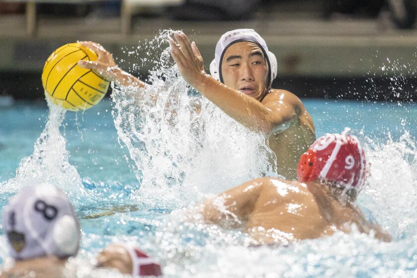 Huntington Beach's Garrett Lee takes a shot against Orange Lutheran's Miles Wilson during a quarterfinal game in the CIF Southern Section Division 1 playoffs at Santiago Canyon College on Thursday, November 7.