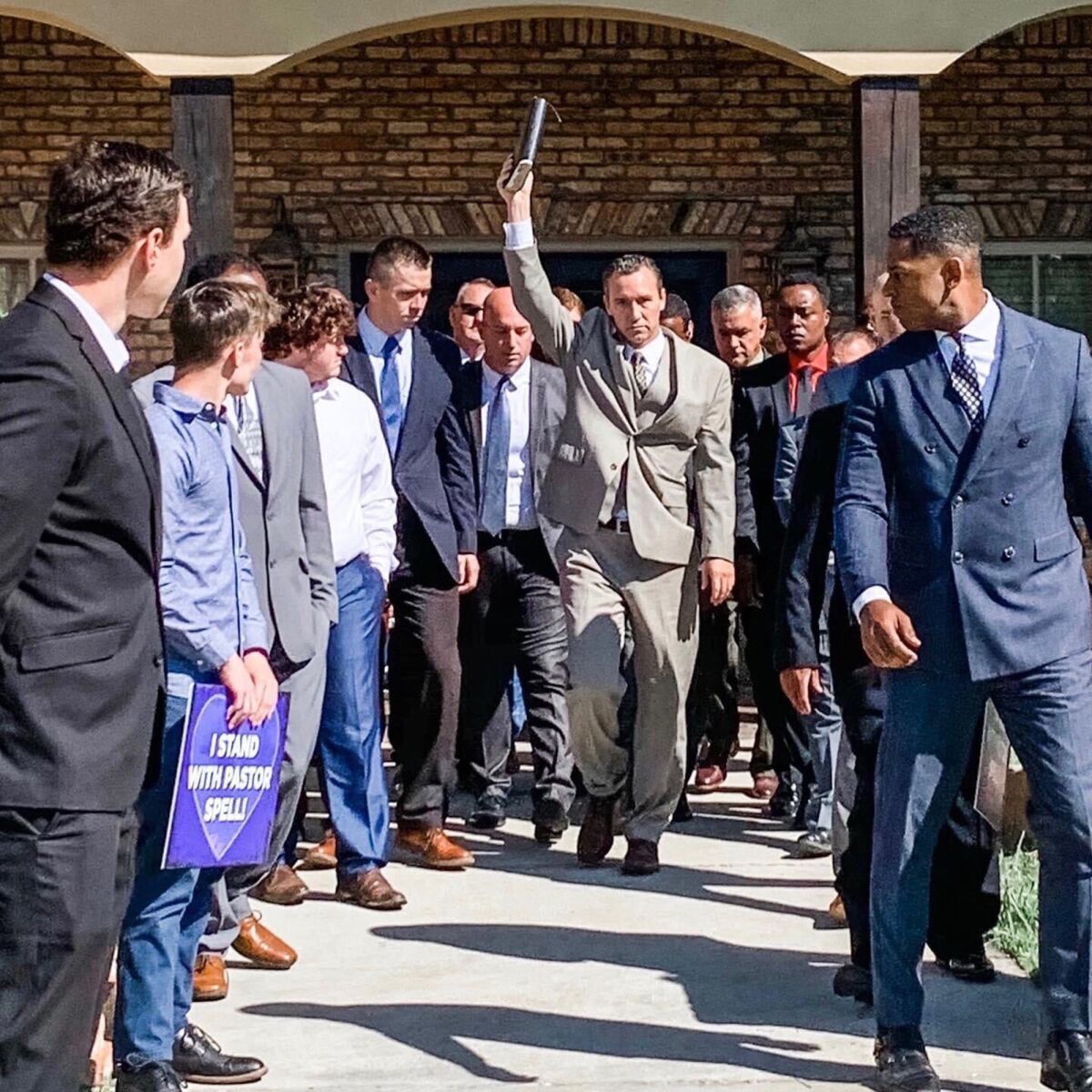 Rev. Tony Spell leaves his home in suburban Baton Rouge, La., where he has been held under house arrest, and walks with members of his congregation to lead Sunday-morning service at Life Tabernacle Church next door.