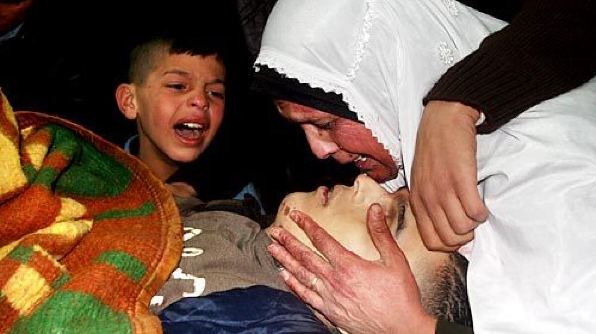 Ahmed Sanakreh's mother and other relatives mourn over his body. The Al Aqsa Martyrs Brigade member was killed by Israeli soldiers in a raid on the Balata refugee camp outside Nablus.