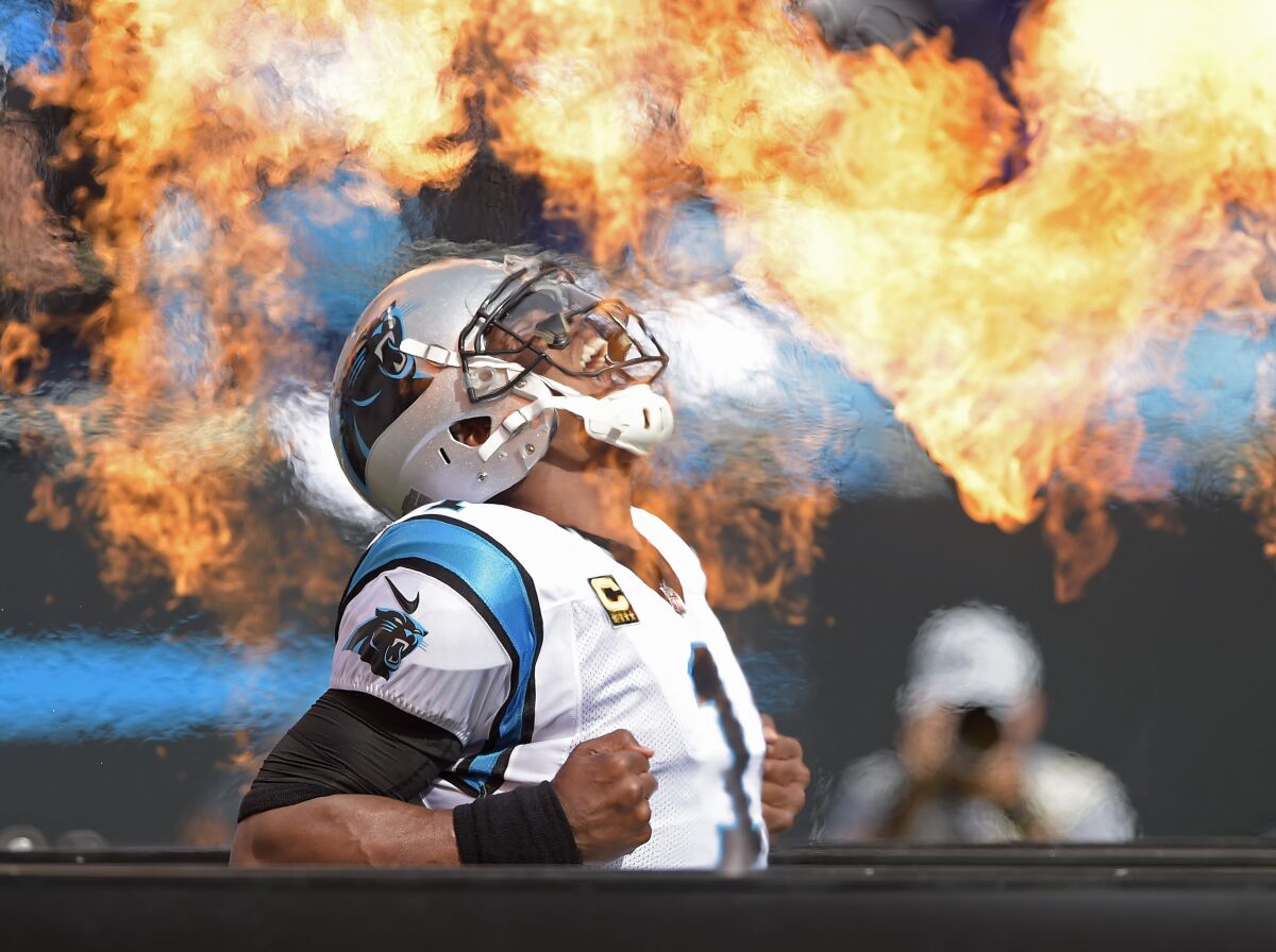 FILE - Carolina Panthers' Cam Newton (1) reacts at he is introduced before an NFL football game against the Dallas Cowboys in Charlotte, N.C., Sunday, Sept. 9, 2018. According to a person with knowledge of the situation, the Carolina Panthers have agreed to a one-year contact to bring quarterback Cam Newton back to the franchise that drafted him No. 1 overall in 2011. The person spoke to The Associated Press on condition of anonymity Thursday, Nov. 11, 2021, because the deal has not been announced by the team.(AP Photo/Mike McCarn, File)