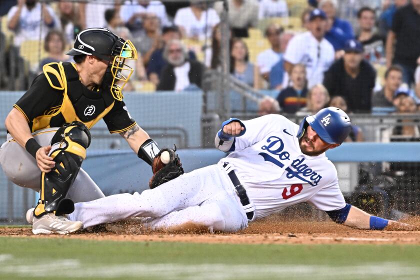 Loa Angeles, California June 1, 2022-Dodgers Gavin Lux is tagged out by Pirates catcher Tyler Heineman in the seventh inning at Dodger Stadium Wednesday. (Wally Skalij/Los Angeles Times)