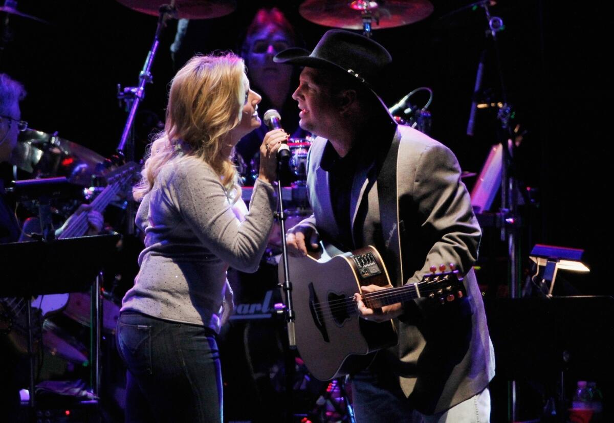 Trisha Yearwood and Garth Brooks perform in Nashville during Nov. 22 tribute to George Jones. Brooks has announced he is ending his self-imposed hiatus from touring with a world tour he will undertake in 2014. No details have been announced.