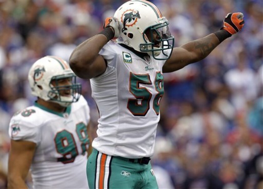 Miami Dolphins' Karlos Dansby (58) celebrates his sack on Buffalo Bills quarterback Trent Edwards (not shown) during the first quarter of an NFL football game in Orchard Park, N.Y., Sunday, Sept. 12, 2010. (AP Photo/ David Duprey)